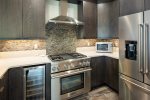 Kitchen is fully appointed and includes wine refrigerator. 